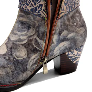 Close-up detail of vintage floral women's boots showing the zipper and leather texture