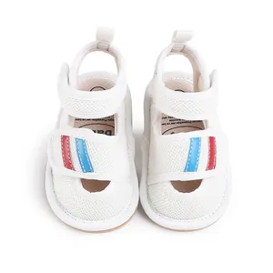 Top view of white baby mesh sandals with red and blue striped velcro straps