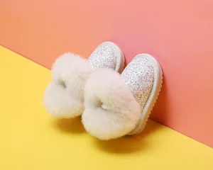 Detailansicht von Baby-Mädchen-Glitzerstiefeln mit flauschigem Kunstpelz und Pailletten