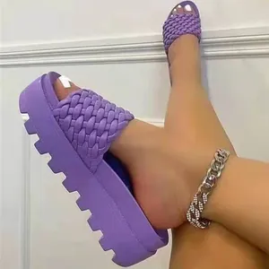 Close-up of purple woven platform slides showing the textured strap and thick sole