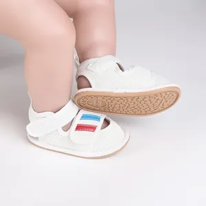 Detailed macro view of white breathable mesh baby walking shoes with slip-resistant sole