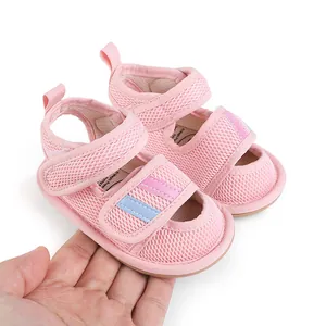 Detailed view of pink mesh baby walking shoes with adjustable hook and loop straps.