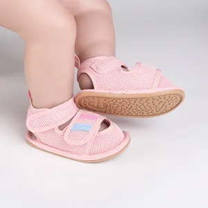Detail view of pink mesh baby walking sandals with non-slip soles and adjustable velcro straps.