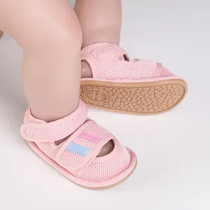 Detail of pink mesh baby walking shoes with anti-slip rubber sole and Velcro straps.