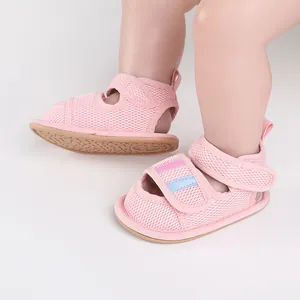 Detail view of pink mesh baby walking sandals with adjustable hook-and-loop strap