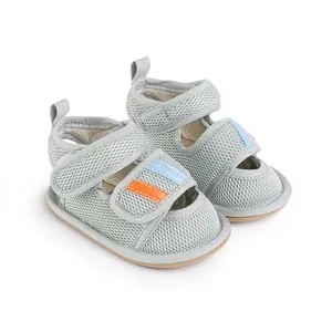 Detailed view of breathable grey mesh baby walking shoes with blue and orange stripes