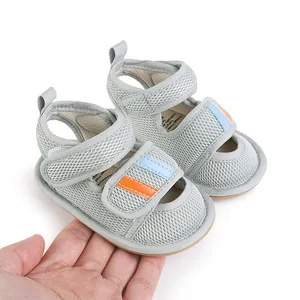 Detailed view of breathable grey mesh baby walking shoes with soft soles and stripes