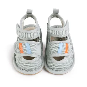 Front view detail of grey mesh baby pre-walker shoes with orange blue stripes