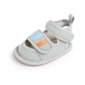 Macro view of grey mesh baby walking shoe showing breathable texture and velcro strap