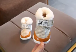 Cozy toddler winter snow boots featuring plaid canvas design and warm white faux fur lining
