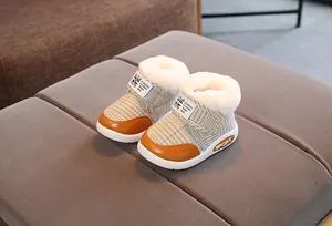 Detail of toddler plaid snow boots with warm plush lining and velcro strap