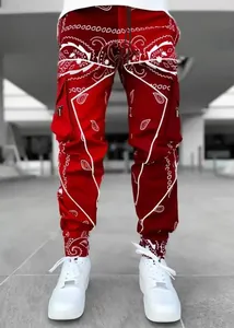Detail of red men's paisley print cargo joggers with functional side pockets.
