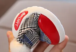 Flexible sole detail of winter baby walking shoes with plaid pattern and fur lining