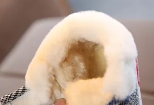 Close-up detail of thick white plush lining inside cozy toddler winter snow boots for warmth