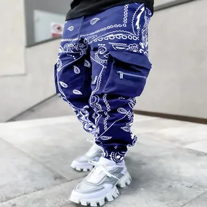 Close-up of blue paisley cargo pants with utility pockets in street fashion style