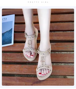 Close-up detail of stylish Bohemian flat sandals with sparkling rhinestones on feet