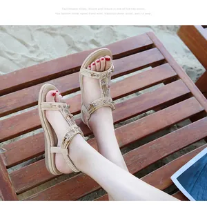 Detailed view of bohemian ladies sandals with sparkling rhinestones on a beach lounge chair
