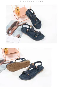 Detailed view of navy Bohemian flat sandals with rhinestone embellishments and sole texture.
