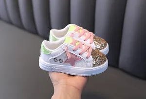 Detailed view of stylish girls glitter sneakers with pink star and gold sequins
