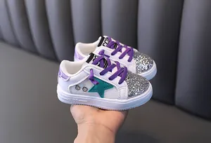 Stylish girls' white sneakers with silver glitter toe and purple laces