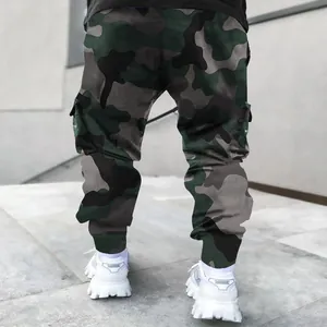 Back view of men's loose camouflage cargo pants with utility pockets in urban setting