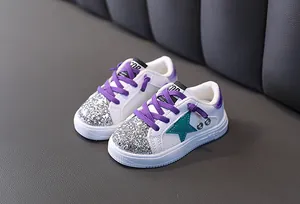 Close-up detail of stylish girls' white and purple sequin casual sneakers with star design