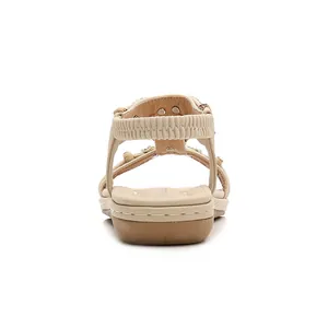 Back view of apricot bohemian flat sandals featuring sparkling rhinestones and elastic strap