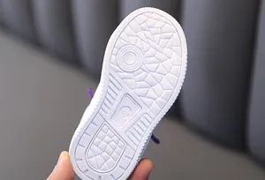 Detailed close-up of a white anti-slip rubber sole on a children's board sneaker.