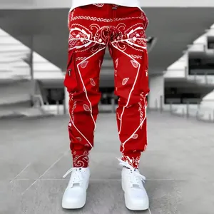 Detail view of men's red paisley cargo pants with multi-pockets and streetwear style