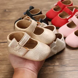 Detailed view of baby princess walking shoes with soft soles and bow accents in gold