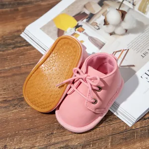 Detailed view of pink baby lace-up boots featuring a non-slip rubber star-patterned sole