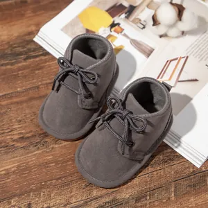 Detailed view of gray suede-style baby lace-up boots with non-slip rubber soles.