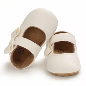 Detailed view of white baby Mary Jane princess walking shoes with elegant bow detail