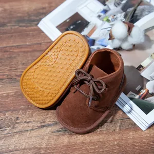 Detail of brown suede baby walking shoes showing non-slip star pattern rubber sole