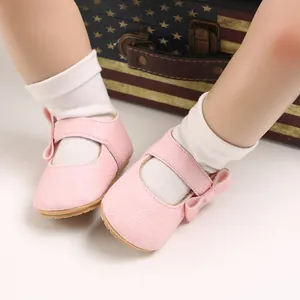 Detailed macro view of pink baby princess shoes with soft soles and cute bow accents