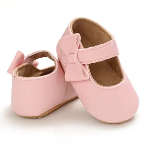 Close-up view of pink soft sole baby princess toddler shoes with a decorative bow
