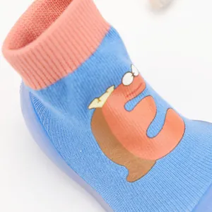 Detail of breathable baby sock shoe with blue knit fabric and cartoon character