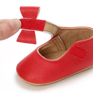 Close-up of red baby princess walking shoe with Velcro bow strap