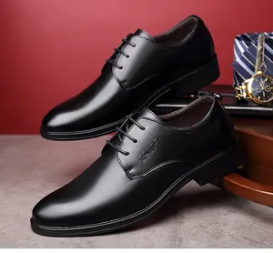 Close-up of black leather business dress shoes with embossed SPORT logo detail.