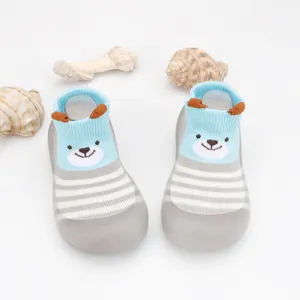 Detail of breathable baby floor socks shoes with soft soles and cartoon bear pattern