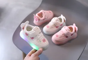 Detailed view of LED light-up baby sneakers with cute bear patterns