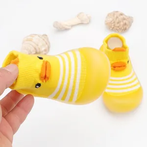 Close-up of yellow cartoon duck baby floor sock shoes featuring a soft breathable sole