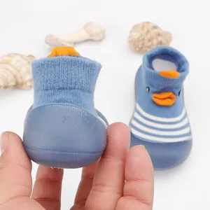 Close-up of baby cartoon duck floor sock shoes with soft non-slip blue rubber sole