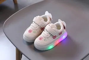 Detail view of toddler LED light-up sneakers featuring cute pink bear and smiley face