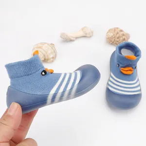 Close-up of blue cartoon duck baby floor socks with flexible soft rubber sole