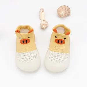 Detail view of breathable hollow mesh baby walking shoes with cartoon pig design