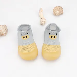 Detail view of breathable cartoon pig baby walking shoes with soft anti-slip soles.