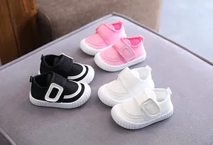 Collection of breathable non-slip baby walking shoes in pink, black, and white colors