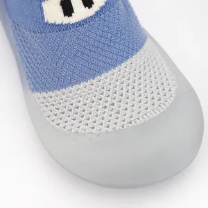 Close-up of breathable mesh fabric and soft rubber toe cap on blue baby walking shoes