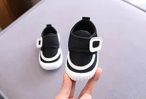 Close-up of black mesh baby walking shoes with soft non-slip sole and velcro strap